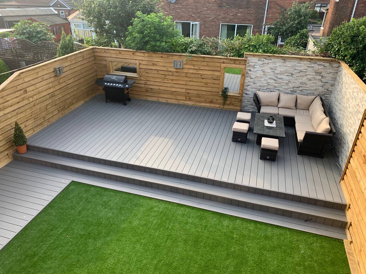 composite decking installed in garden with furniture on it