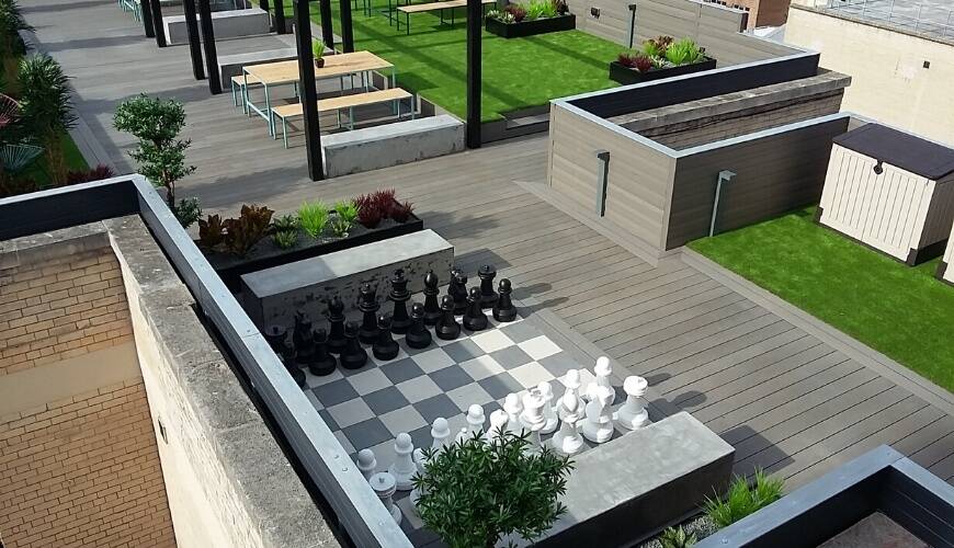 Rooftop terrace with composite decking and a giant chess set