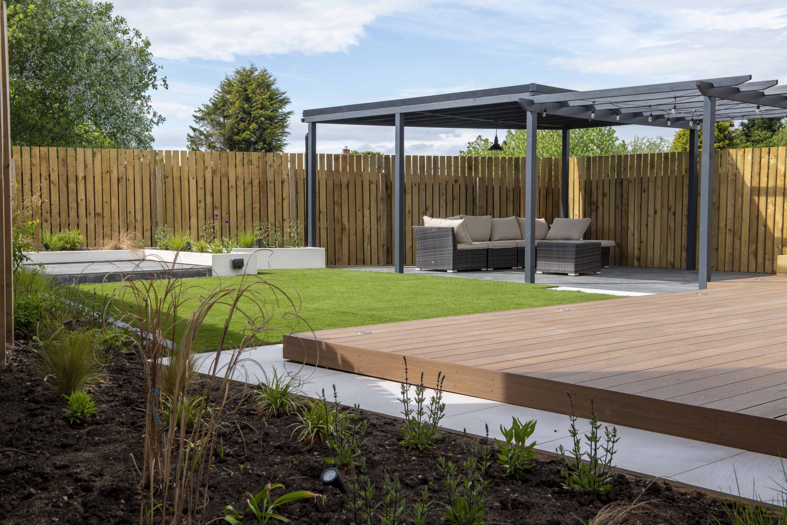 Spiced Oak composite decking under a pergola