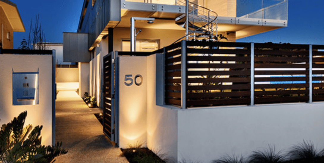 Composite screening at a front entrance with a lit house number