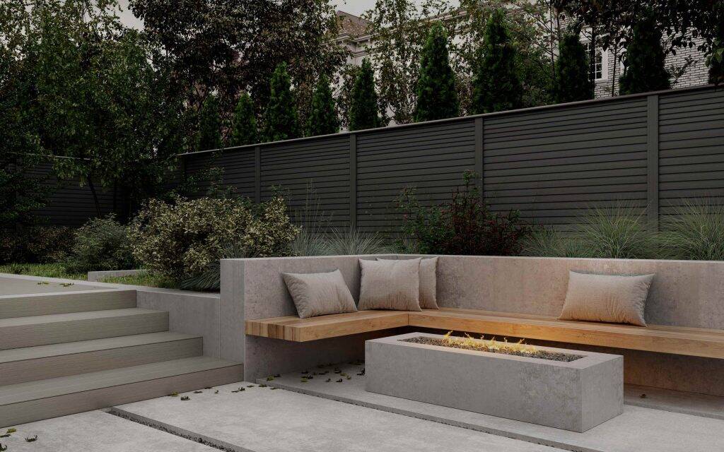 Charcoal composite fencing behind a garden lounger
