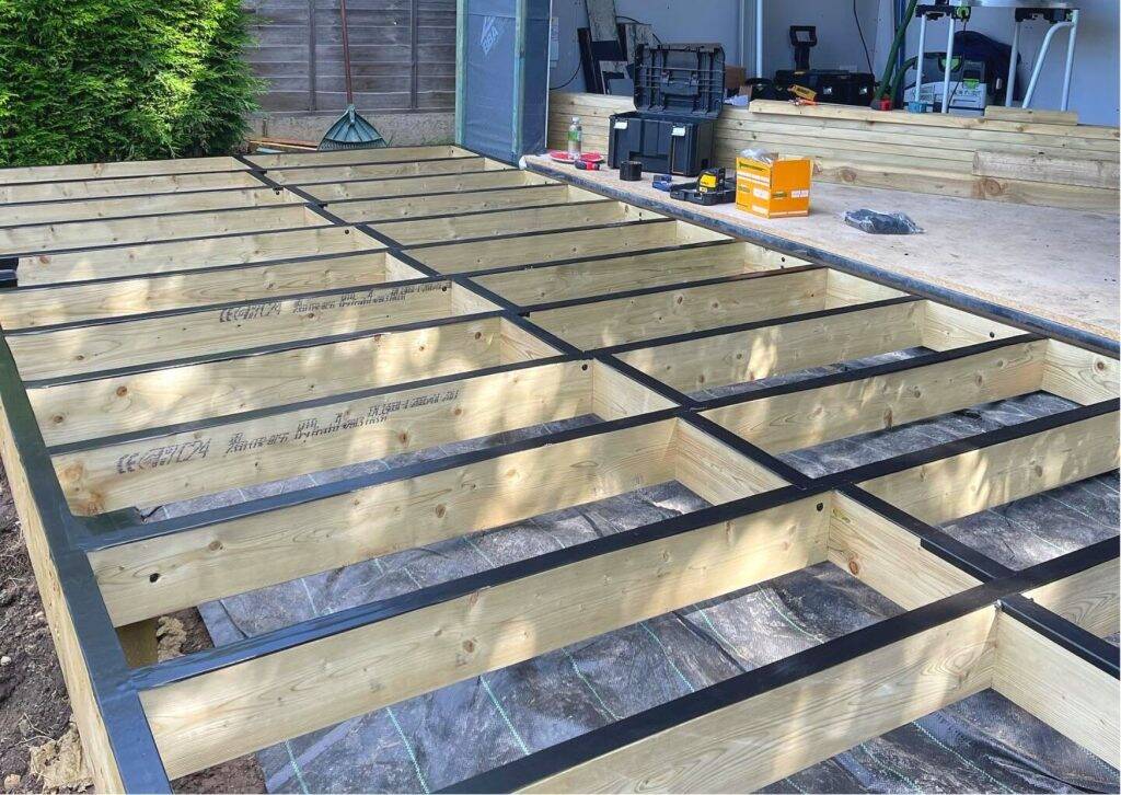 Waterproofing tape fitted along decking joists
