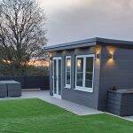 Covered garden seating area with composite decking and grey composite fencing